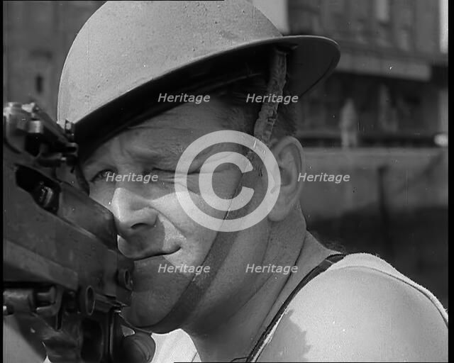 British Sailors Mounting Machine Guns To Small Boats for the Dunkirk Evacuation, 1940. Creator: British Pathe Ltd.