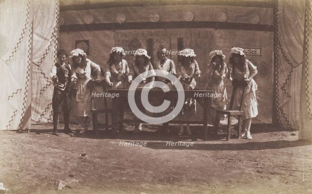 British servicemen in drag acting out a cooking class, 1918. Creator: Unknown.