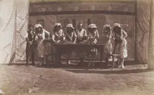 British servicemen in drag acting out a cooking class, 1918. Creator: Unknown