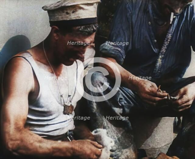 British Soldier Counting Bullets on Board a Ship Evacuating Him from Dunkirk, 1940. Creator: British Pathe Ltd.