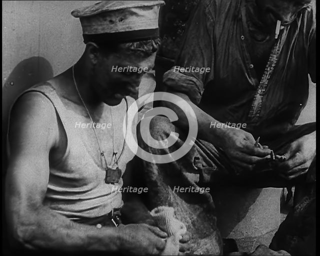 British Soldier Counting Bullets on Board a Ship Evacuating Him from Dunkirk, 1940. Creator: British Pathe Ltd.
