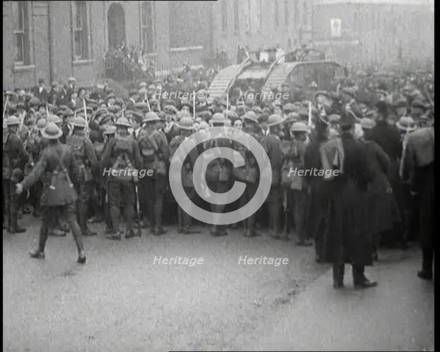 British Soldiers Holding Back Crowds of Demonstrators in Dublin as a Tank Moves Through to..., 1920. Creator: British Pathe Ltd.