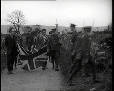 British Soldiers Marching a Sinn Fein Supporter Down a Country Lane, Forcing Him to Bear..., 1920. Creator: British Pathe Ltd