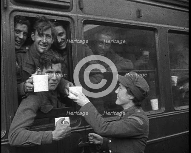 British Soldiers Receiving Food and Drink on the Train Back To Camp, 1940. Creator: British Pathe Ltd.
