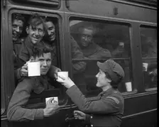 British Soldiers Receiving Food and Drink on the Train Back To Camp, 1940. Creator: British Pathe Ltd