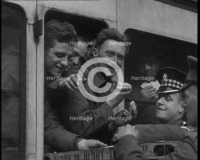 British Soldiers Receiving Food and Drink on the Train Back To Camp, 1940. Creator: British Pathe Ltd.