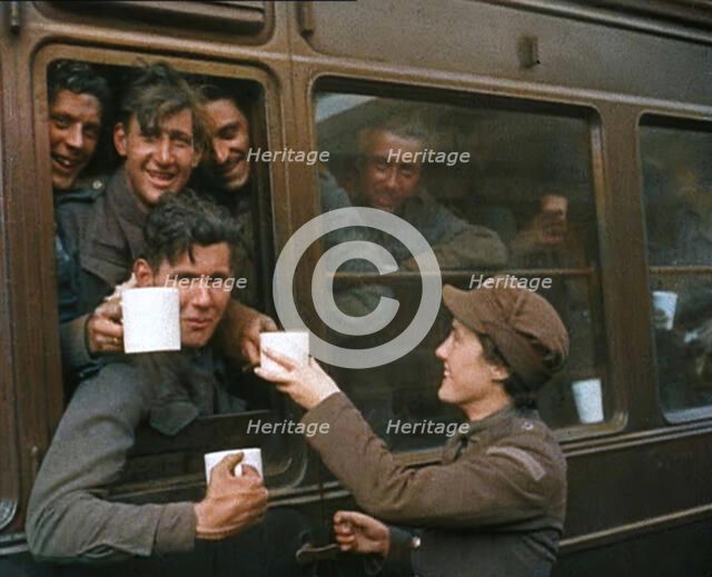 British Soldiers Receiving Food and Drink on the Train Back To Camp, 1940. Creator: British Pathe Ltd.