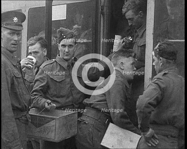 British Soldiers Receiving Food and Drinks on Trains Taking Them To Camp, 1940. Creator: British Pathe Ltd.
