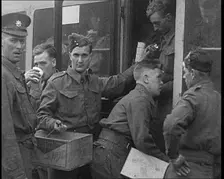 British Soldiers Receiving Food and Drinks on Trains Taking Them To Camp, 1940. Creator: British Pathe Ltd