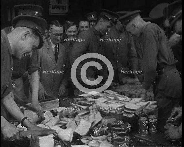 British Soldiers Receiving Food and Drinks at Camp, 1940. Creator: British Pathe Ltd.