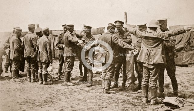 British soldiers searching captured German prisoners, Somme campaign, France, World War I, 1916. Creator: Unknown.
