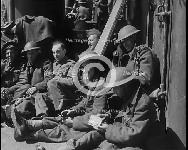 British Soldiers Sitting Aboard a Ship Taking Them Across the Channel Following the..., 1940. Creator: British Pathe Ltd.