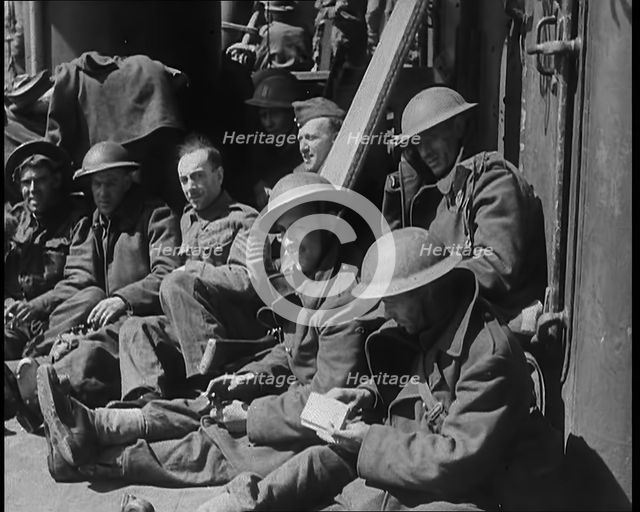 British Soldiers Sitting Aboard a Ship Taking Them Across the Channel Following the..., 1940. Creator: British Pathe Ltd.