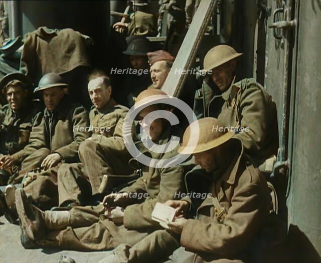 British Soldiers Sitting Aboard a Ship Taking Them Across the Channel Following the..., 1940. Creator: British Pathe Ltd.