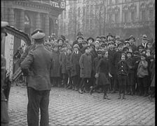 British Soldiers Standing by a Tank in a German Town as Civilians Look On, 1921. Creator: British Pathe Ltd