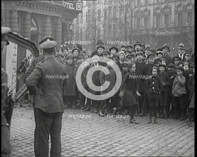British Soldiers Standing by a Tank in a German Town as Civilians Look On, 1921. Creator: British Pathe Ltd.