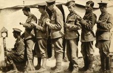 British soldiers synchronising their watches on the front line, First World War, 1914-1918, (1933). Creator: Unknown