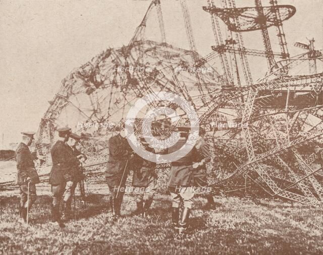 British staff officers examining the wreckage of a Zeppelin brought down in England, c1917 (1919). Artist: Unknown.