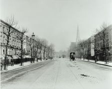 Broad tree-lined street with tramlines, Burdett Road, Stepney, London, 1912