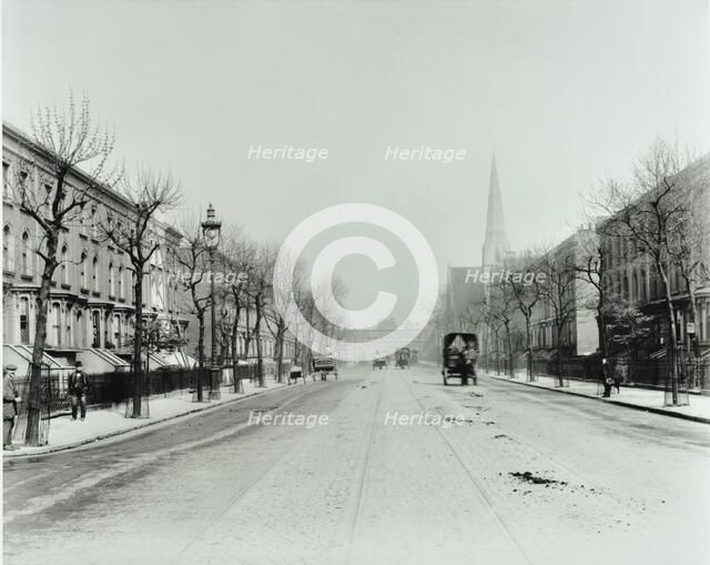 Broad tree-lined street with tramlines, Burdett Road, Stepney, London, 1912. Artist: Unknown.