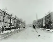 Broad tree-lined street with tramlines, Burdett Road, Stepney, London, 1912