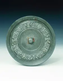 Bronze mirror with multi-armed Avalokitesvara and characters, Yuan dynasty, China, 1271-1368. Creator: Unknown