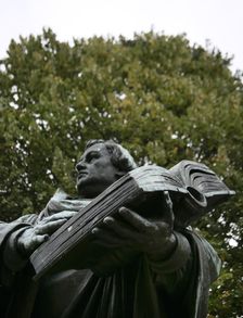 Bronze statue of Martin Luther next to the Marienkirche, (St Mary's Church), Berlin, Germany, 2025. Creator: LTL
