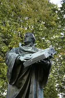 Bronze statue of Martin Luther next to the Marienkirche, (St Mary's Church), Berlin, Germany, 2025. Creator: LTL