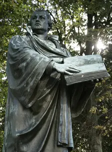 Bronze statue of Martin Luther next to the Marienkirche, (St Mary's Church), Berlin, Germany, 2025. Creator: LTL