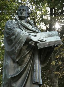 Bronze statue of Martin Luther next to the Marienkirche, (St Mary's Church), Berlin, Germany, 2025. Creator: LTL