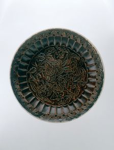 Brown Ding saucer with moulded floral decoration, Jin dynasty, China, late 12th-early 13th century