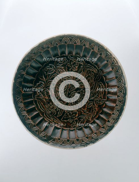 Brown Ding saucer with moulded floral decoration, Jin dynasty, China, late 12th-early 13th century. Artist: Unknown
