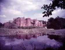 Broughton Castle and moat, Oxfordshire, c1955. [gateway, church] Creator: Arthur Charles Kirby Ware