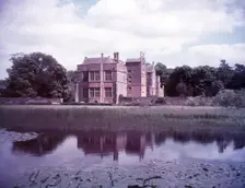 Broughton Castle and moat, Oxfordshire, c1955. [gateway, church] Creator: Arthur Charles Kirby Ware