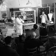Butcher from Danish Bacon giving a demonstration, Kilnhurst, South Yorkshire, 1961. Creator: Michael Walters