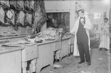 Butcher stands idle before his counter of meat during the meat boycott, 1910. Creator: Bain News Service
