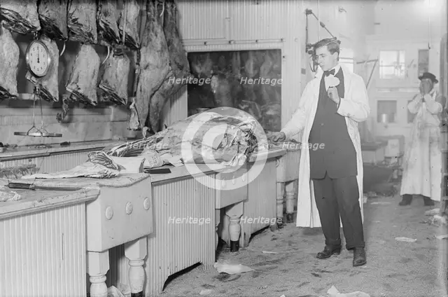 Butcher stands idle before his counter of meat during the meat boycott, 1910. Creator: Bain News Service.