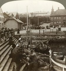 Buying fish in a busy Arctic trading port, Tromsoe (69° 38 N. Lat.), Northern Norway 1902. Creator: Unknown