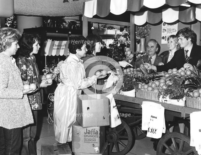 Buying Israeli Jaffa oranges for charity at Selfridges, London, 1981. Creator: Sidney Harris.