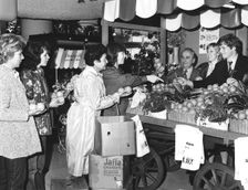 Buying Israeli Jaffa oranges for charity at Selfridges, London, 1981. Creator: Sidney Harris