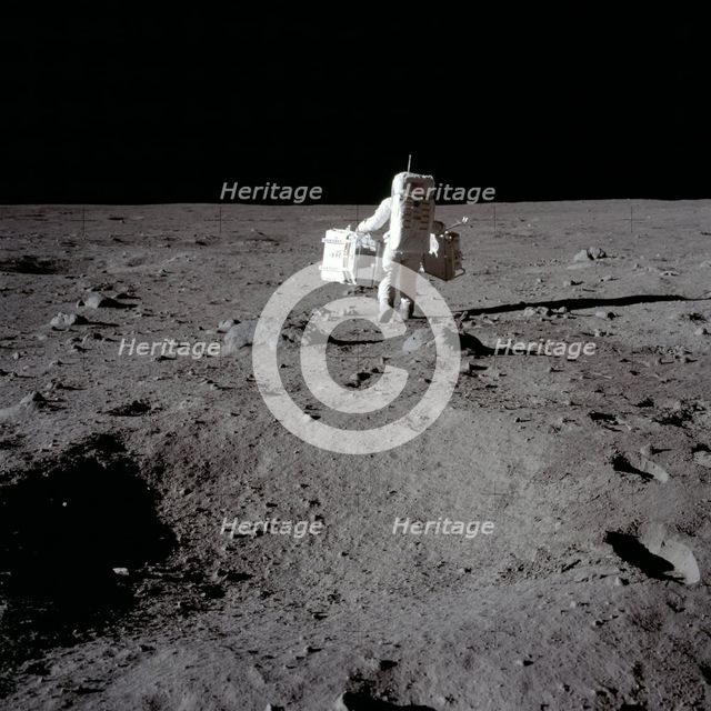 Buzz Aldrin carries out an experiment on the lunar surface, Apollo II mission, July 1969.  Creator: Neil Armstrong.