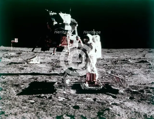 Buzz Aldrin sets up the seismic experiment, Apollo II mission, July 1969.  Creator: Neil Armstrong.