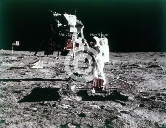 Buzz Aldrin sets up the seismic experiment, Apollo II mission, July 1969.  Creator: Neil Armstrong.
