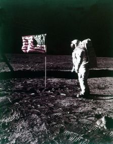 Buzz Aldrin stands next to the American flag on the surface of the Moon, July 1969. Creator: Neil Armstrong