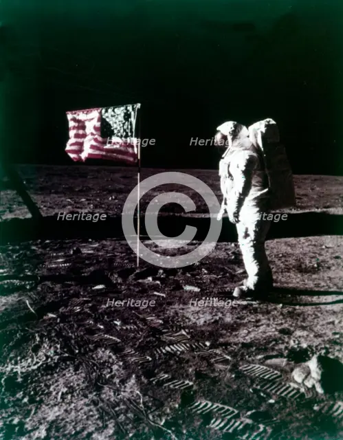 Buzz Aldrin stands next to the American flag on the surface of the Moon, July 1969. Creator: Neil Armstrong.
