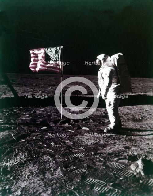 Buzz Aldrin stands next to the American flag on the surface of the Moon, July 1969. Creator: Neil Armstrong.