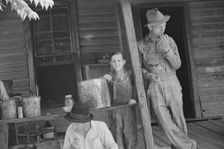 Bud Fields, Tengle boy, and Floyd Burroughs on Frank Tengle's porch, Hale County, Alabama, 1936. Creator: Walker Evans