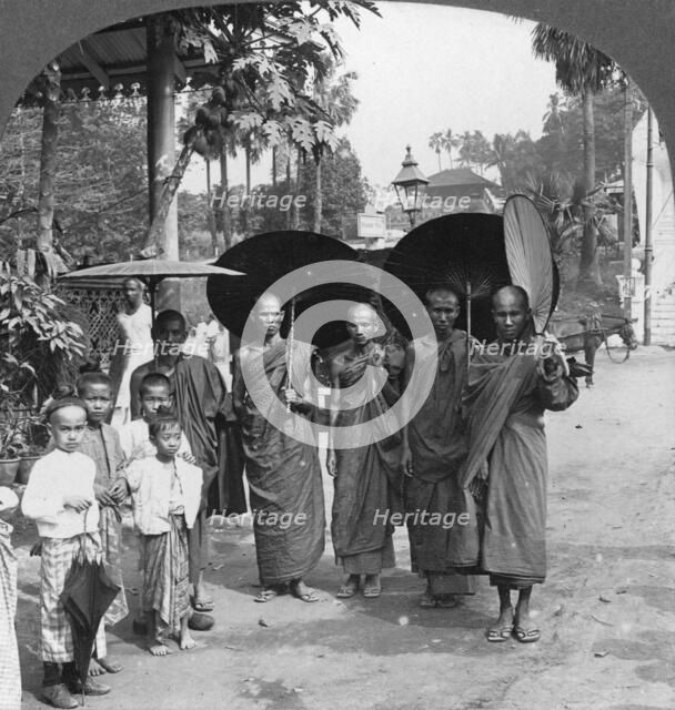 Buddhist monks with sunshades and fans, Rangoon, Burma, 1908. Artist: Stereo Travel Co