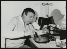 Buddy Rich eating backstage at Ronnie Scott's Jazz Club, London, 1979. Creator: Denis Williams