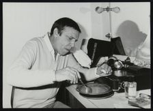 Buddy Rich eating backstage at Ronnie Scott's Jazz Club, London, 1979. Creator: Denis Williams